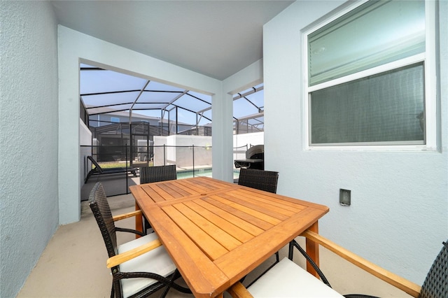 dining area with a textured wall, concrete floors, and a sunroom