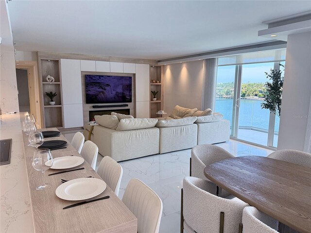 living room with built in features and marble finish floor