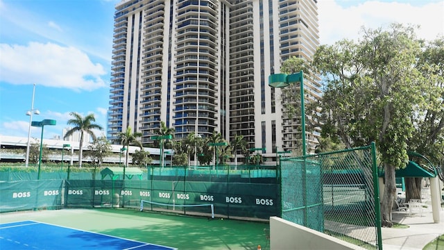 view of tennis court featuring fence