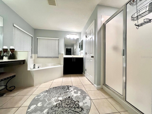 bathroom with tile patterned flooring, visible vents, a stall shower, a bath, and vanity