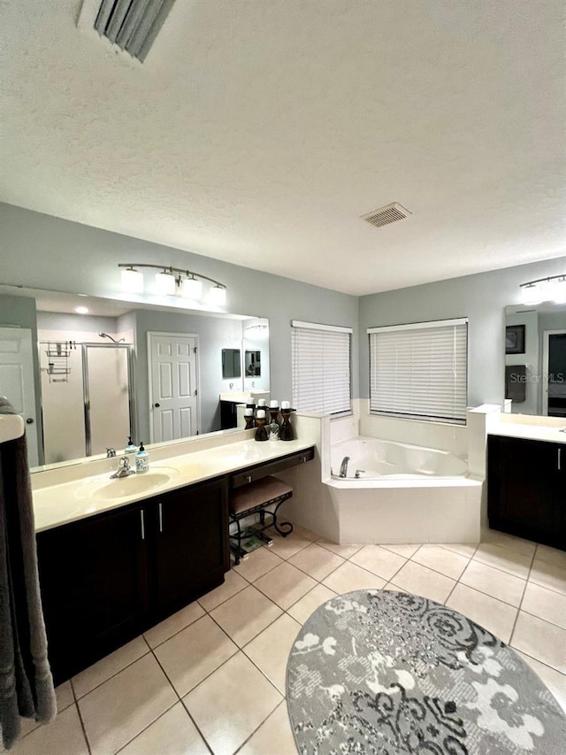 full bath featuring visible vents, a shower stall, a bath, tile patterned floors, and vanity