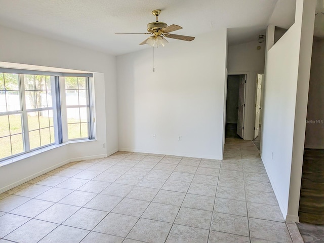 unfurnished room featuring light tile patterned floors, baseboards, and ceiling fan