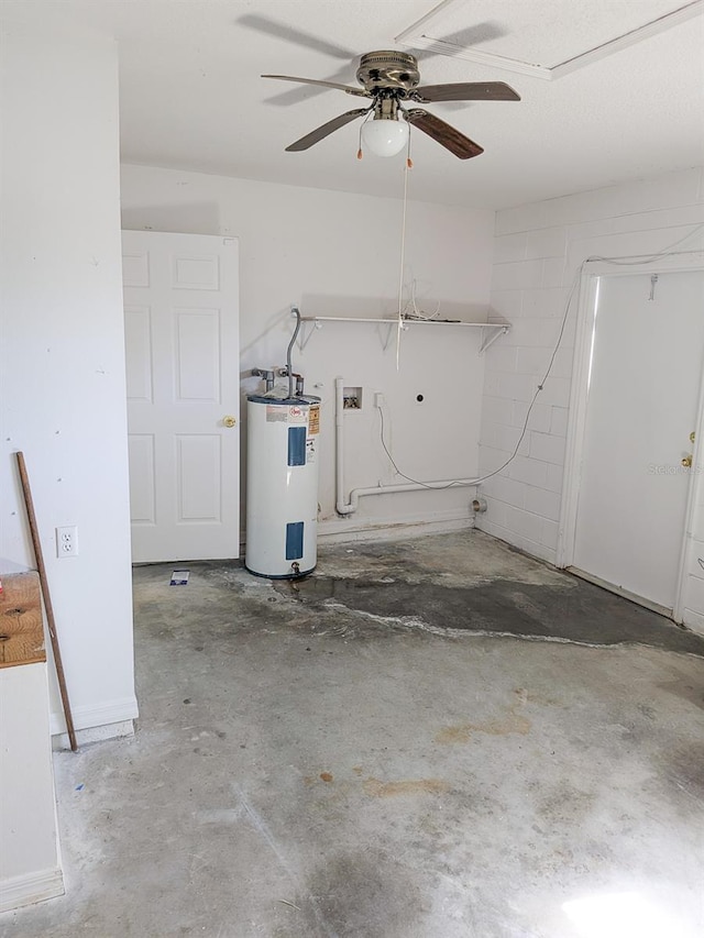 garage featuring concrete block wall, a ceiling fan, and electric water heater