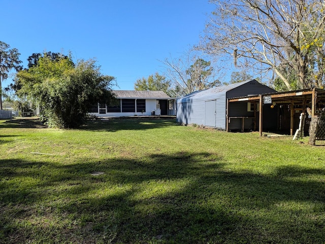 view of yard with an outdoor structure and a sunroom