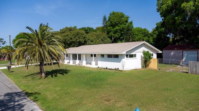 single story home featuring stucco siding, a front yard, and fence