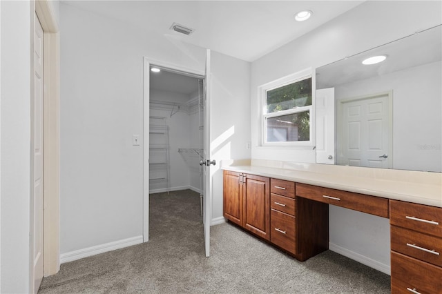 bathroom with vanity, carpet, visible vents, and baseboards