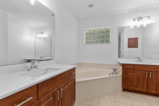 full bath featuring tile patterned flooring, a garden tub, two vanities, and a sink