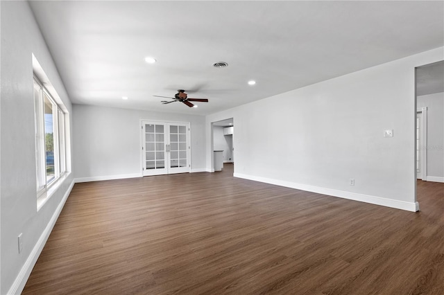 unfurnished living room with a ceiling fan, baseboards, visible vents, dark wood-style flooring, and french doors