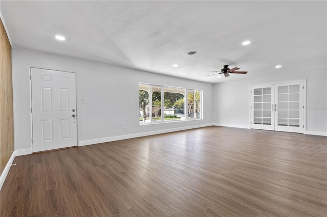 unfurnished living room featuring dark wood finished floors, visible vents, recessed lighting, and baseboards