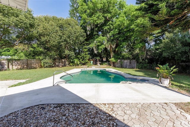 view of pool with a fenced backyard, a yard, and a patio