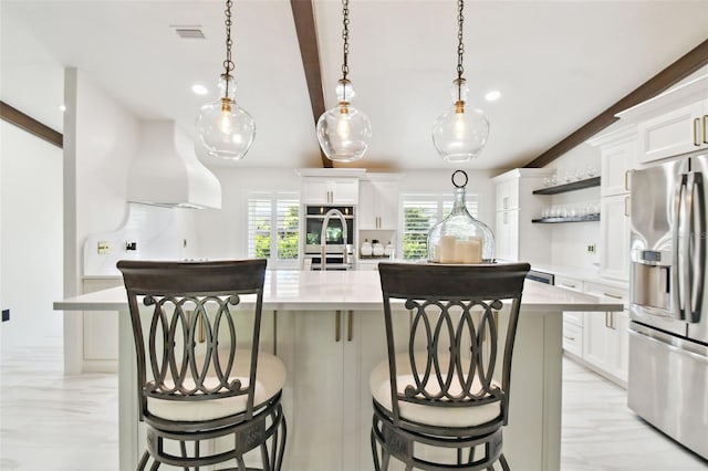 kitchen featuring light countertops, custom range hood, open shelves, and stainless steel appliances