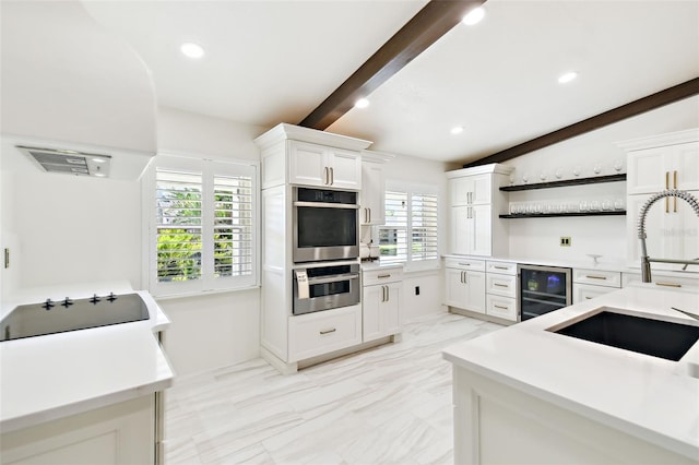 kitchen with stainless steel double oven, open shelves, a sink, wine cooler, and black electric cooktop