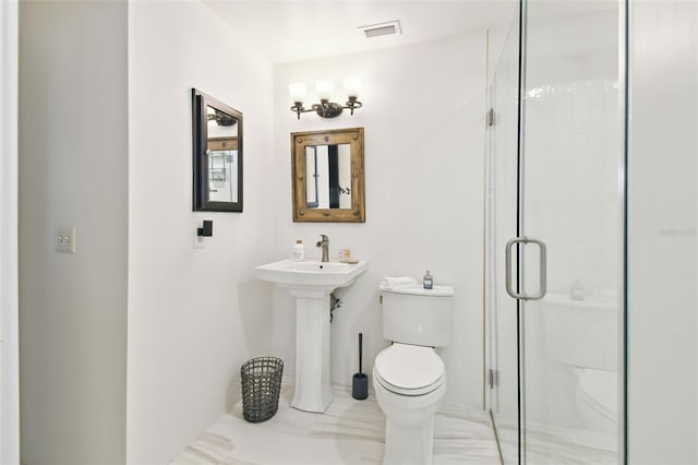 bathroom featuring visible vents, toilet, and a stall shower