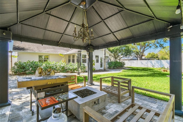 view of patio / terrace with a gazebo, an outdoor fire pit, and fence