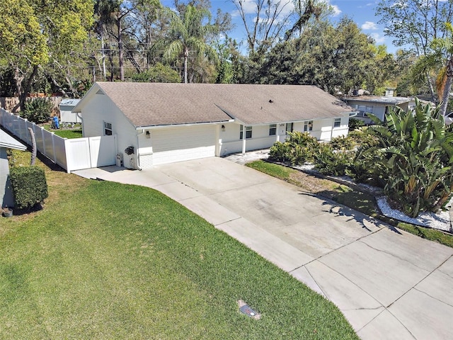 view of front of property featuring a shingled roof, fence, concrete driveway, a front yard, and an attached garage