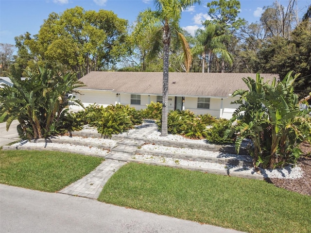 single story home with a front lawn and stucco siding