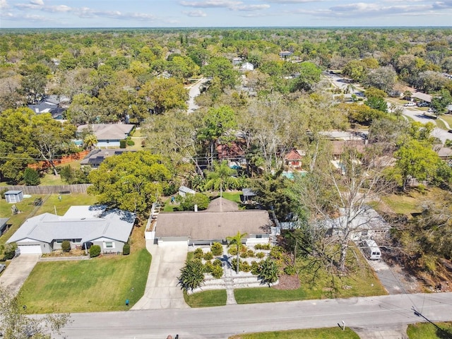 drone / aerial view featuring a view of trees and a residential view