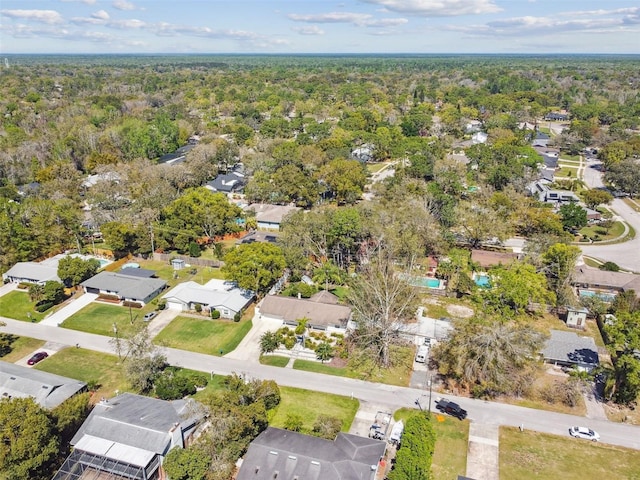 drone / aerial view with a residential view and a wooded view