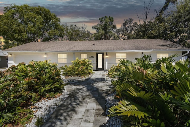 ranch-style house featuring stucco siding and an attached garage