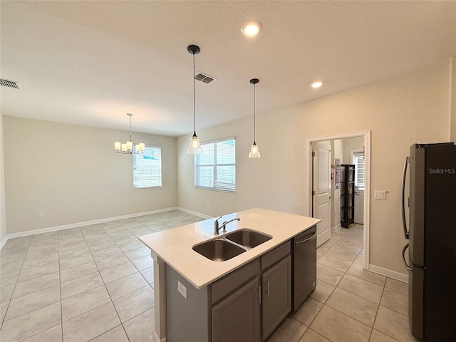 kitchen with visible vents, a sink, light countertops, appliances with stainless steel finishes, and pendant lighting