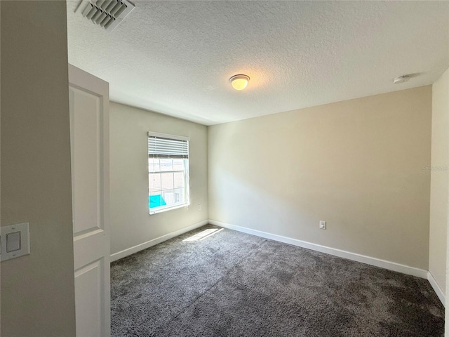 carpeted empty room featuring visible vents, a textured ceiling, and baseboards