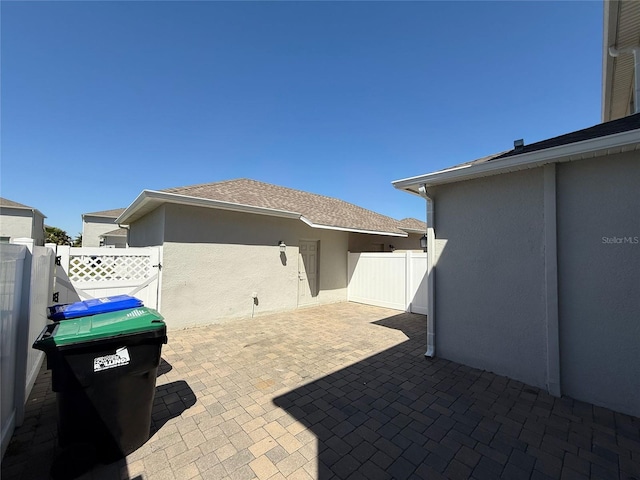 view of patio featuring a gate and fence