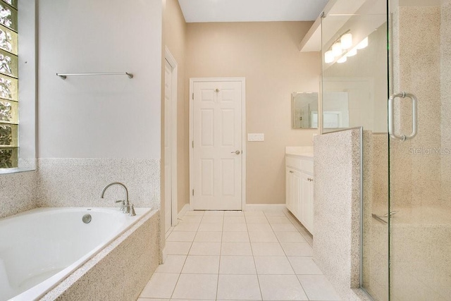 full bath featuring tile patterned flooring, a shower stall, vanity, and a garden tub