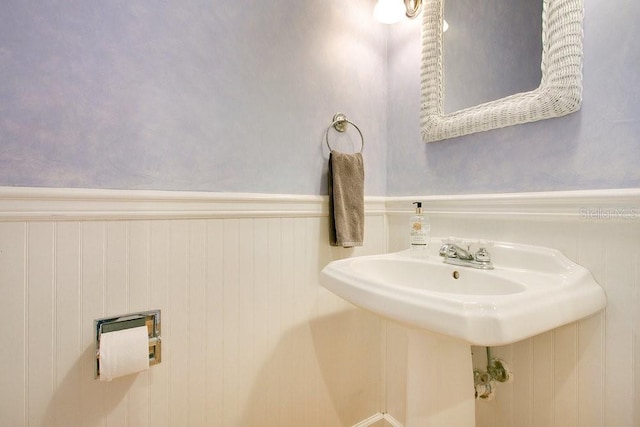 bathroom featuring a sink and wainscoting