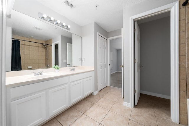 full bath featuring tile patterned flooring, visible vents, and a sink