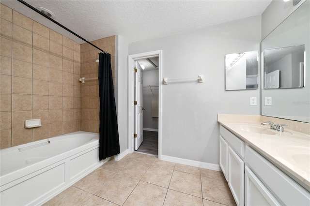 bathroom with shower / tub combo with curtain, double vanity, tile patterned floors, a textured ceiling, and a sink