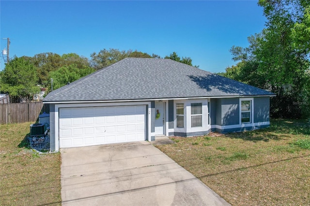 ranch-style house with a front lawn, concrete driveway, central AC, roof with shingles, and a garage