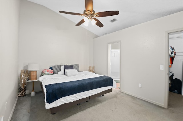 bedroom with visible vents, a walk in closet, a closet, carpet, and lofted ceiling