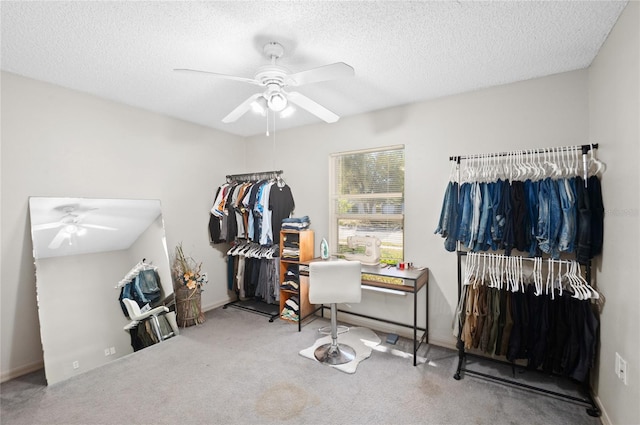 interior space with baseboards, carpet floors, a textured ceiling, and ceiling fan