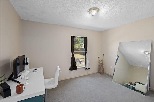 home office with a textured ceiling, baseboards, and carpet floors