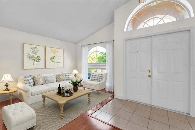 entrance foyer with light tile patterned floors and lofted ceiling