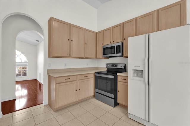 kitchen featuring light countertops, light brown cabinets, and appliances with stainless steel finishes