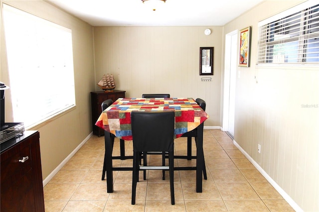 dining space with light tile patterned floors and baseboards