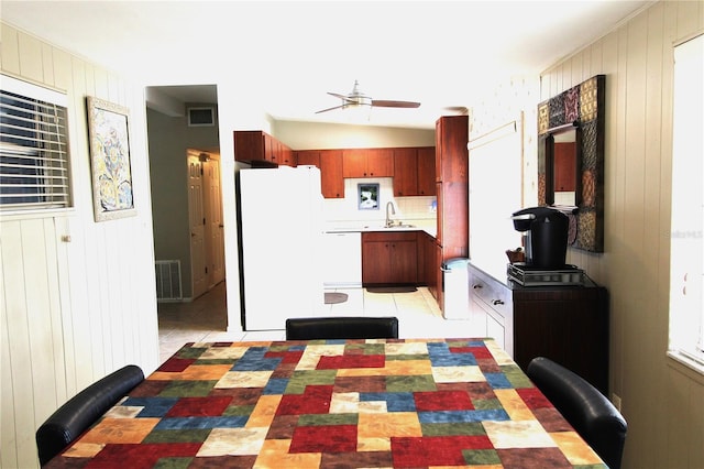 kitchen featuring visible vents, white appliances, light countertops, and a sink