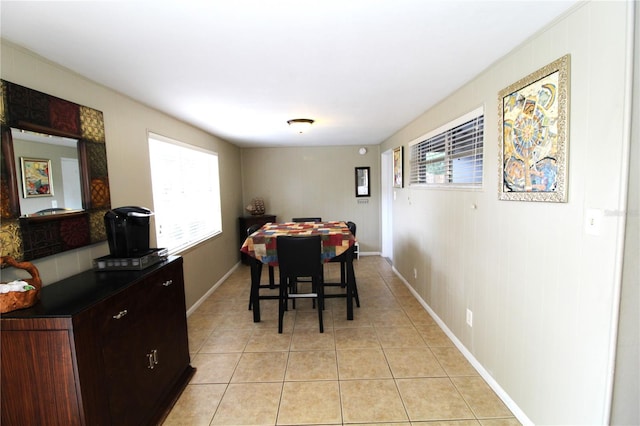 dining area featuring light tile patterned floors and baseboards