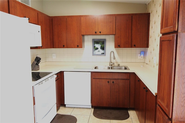 kitchen featuring dishwashing machine, backsplash, electric range, and a sink