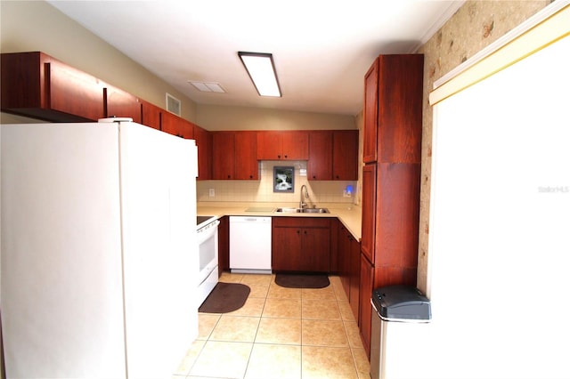 kitchen with visible vents, light countertops, light tile patterned floors, white appliances, and a sink