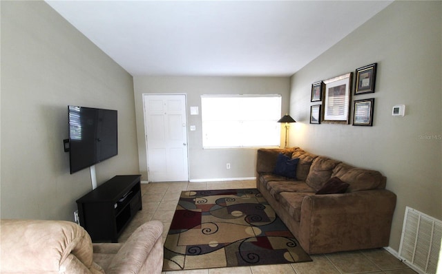 living room featuring visible vents, baseboards, and tile patterned flooring