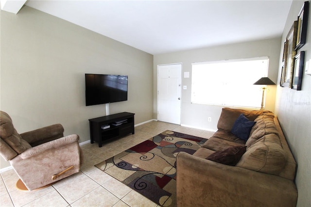 living area with light tile patterned floors and baseboards