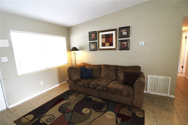 living room with visible vents, baseboards, and tile patterned flooring