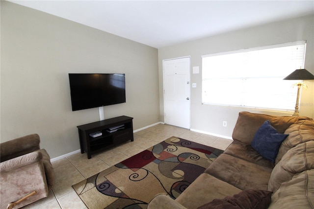 living area featuring light tile patterned floors and baseboards