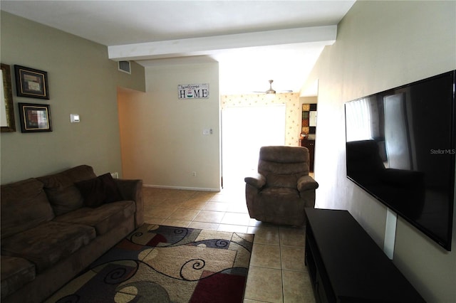 living area with visible vents, beamed ceiling, light tile patterned flooring, and a ceiling fan