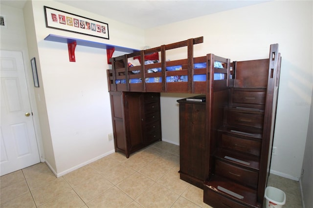 bedroom with light tile patterned flooring, baseboards, and visible vents