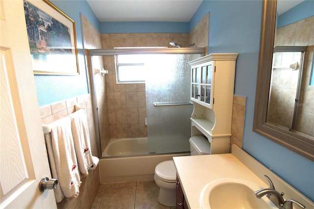 full bathroom with tile patterned floors, enclosed tub / shower combo, toilet, and vanity