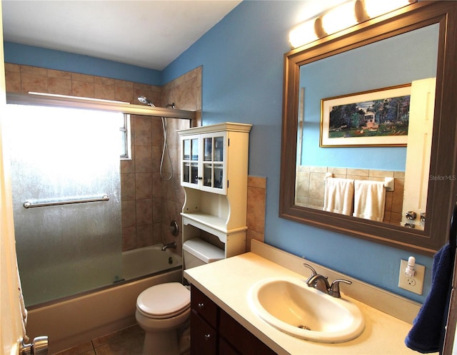 full bathroom with tile patterned floors, toilet, vanity, and shower / bath combination with glass door