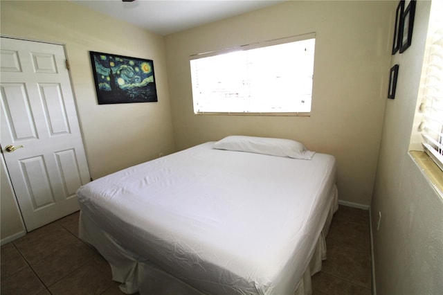 bedroom featuring tile patterned flooring and baseboards